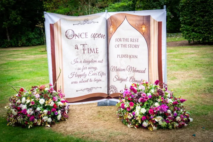 Storybook wedding welcome sign with flowers