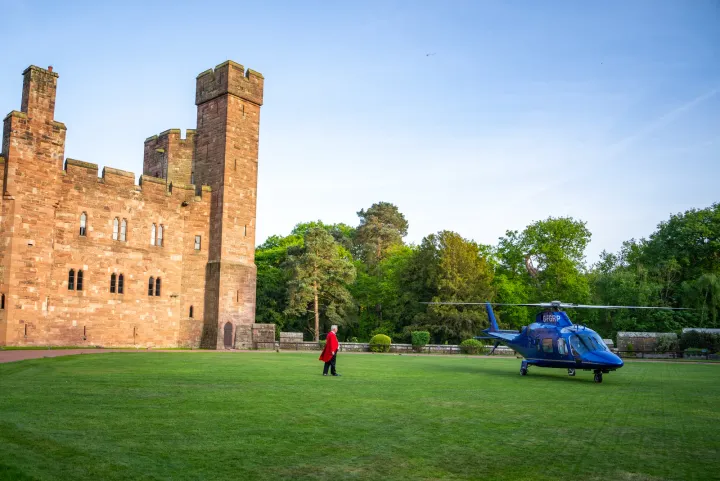 Helicopter arrival on a castle lawn