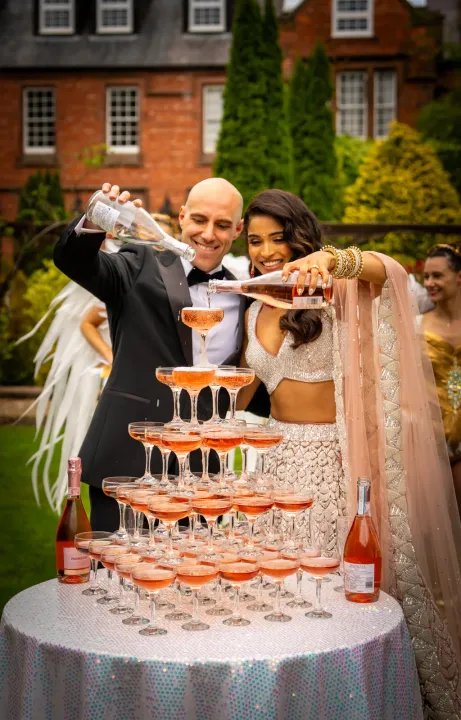 Couple pouring drinks into a glass tower