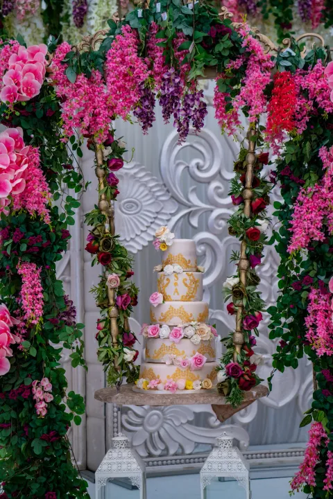 Wedding cake beneath trailing pink flowers