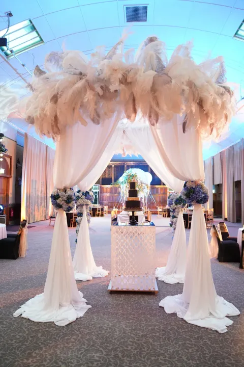 White draped canopy with feather decorations