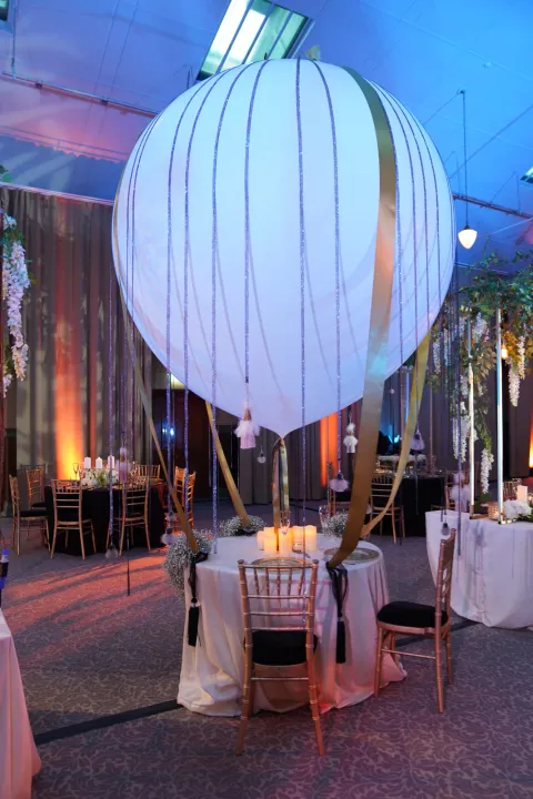 Large white lantern above an event seating area