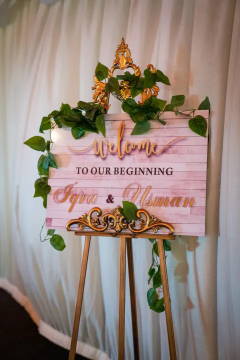 Decorative welcome sign framed by foliage
