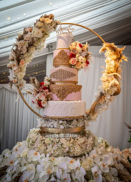 Wedding cake suspended in a circular floral frame
