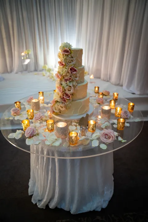 Wedding cake on a candlelit display table