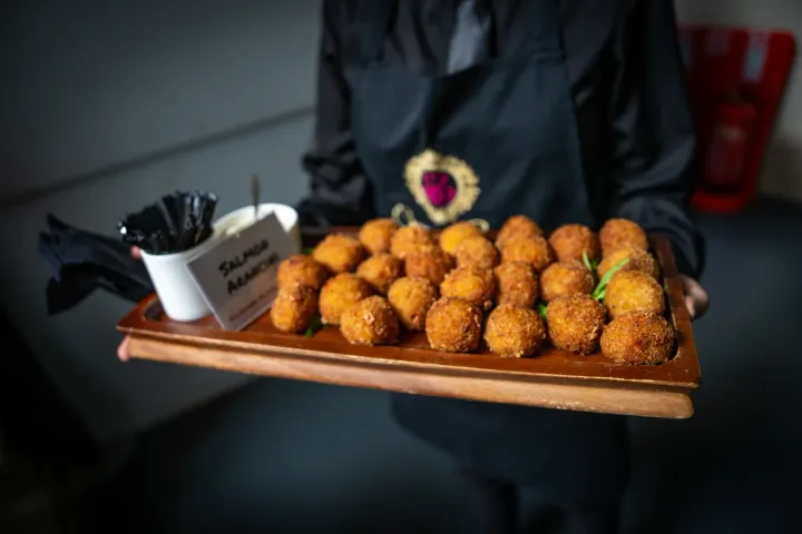 Crisp golden canapés presented on a wooden tray