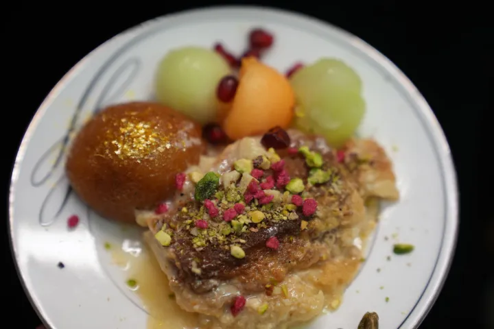 A plated selection of sweets and fresh fruit