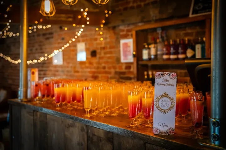 Colourful welcome drinks arranged in a rustic hall