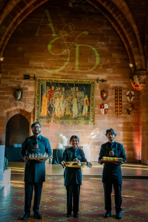 Catering team beneath an ornate timber roof