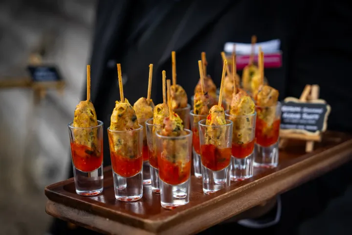 Individual canapé glasses presented on a tray