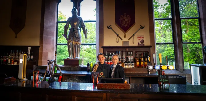 Catering team behind a bar with garden views