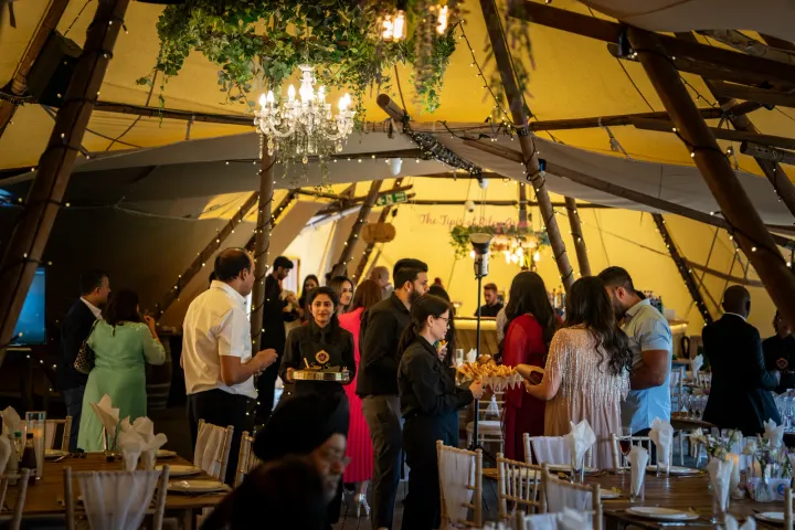 Guests gathering inside a timber-framed reception space