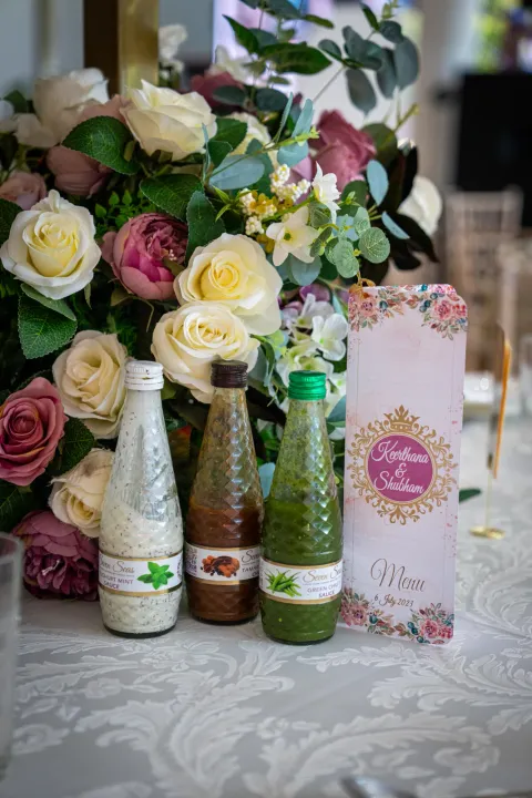 Bottled drinks and flowers on a reception table