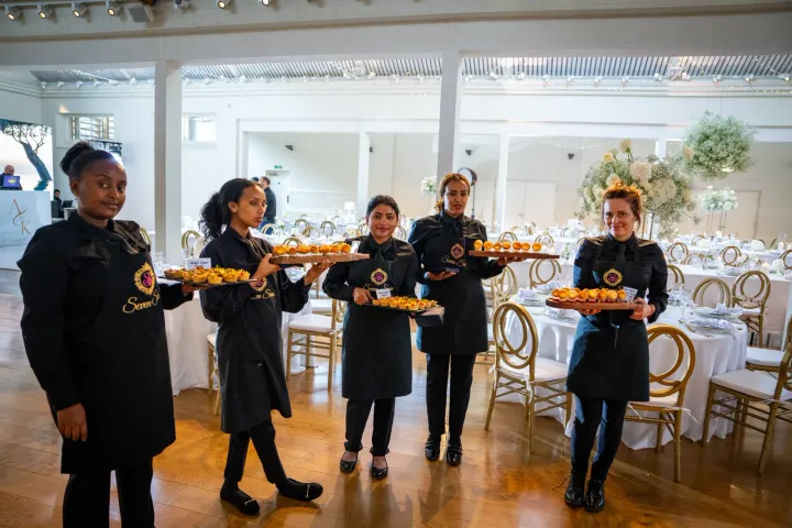 Catering team ready for service in a bright reception room