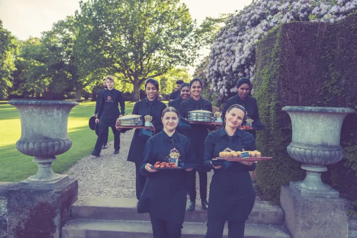 Catering team gathered on garden steps