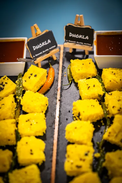 Dhokla arranged on long serving platters