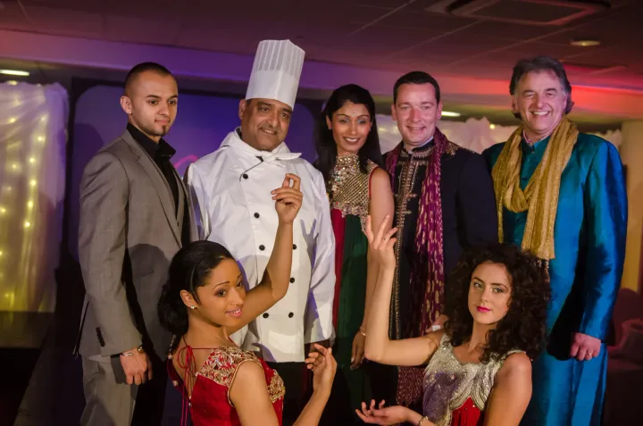 Chef and guests posing together at a celebration