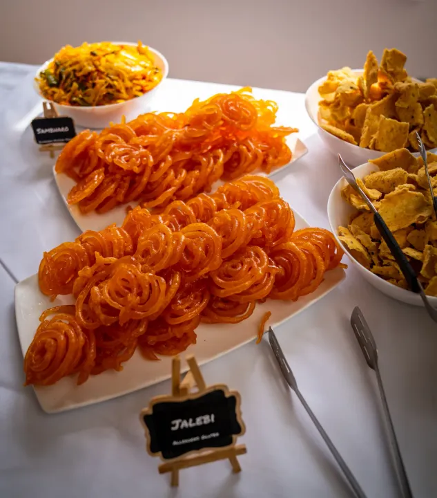 Jalebi and other sweets arranged on a buffet
