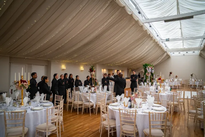 Catering team preparing an elegantly dressed marquee