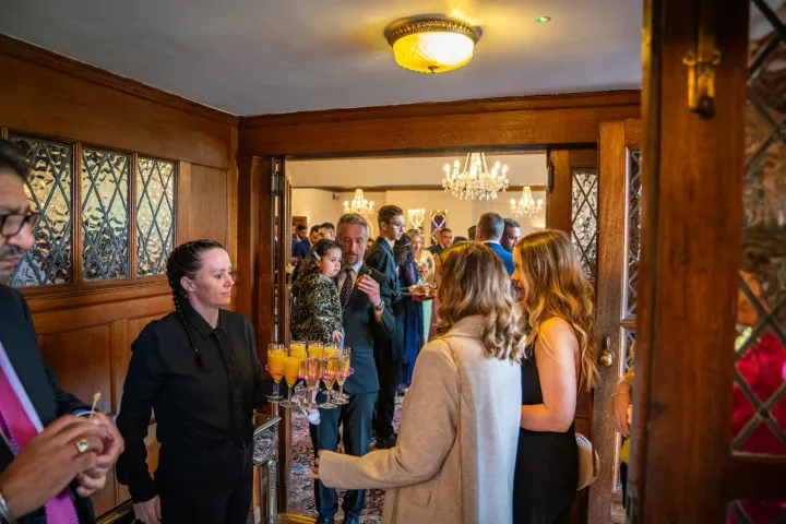 Guests enjoying canapés in a timber-framed room