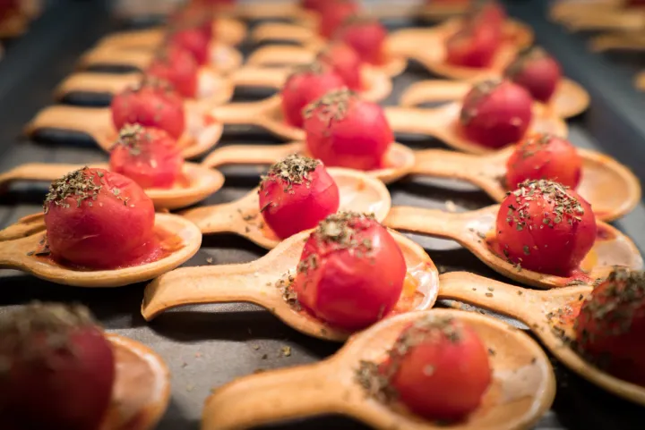 Pink savoury bites presented on tasting spoons