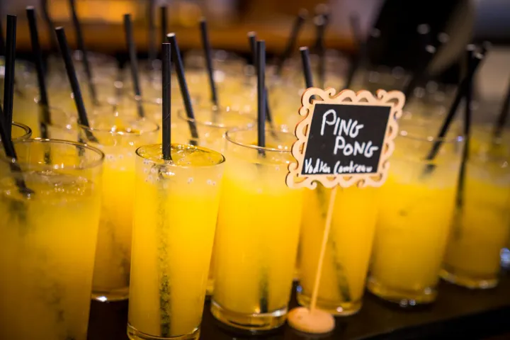 Yellow mocktails with straws ready for service