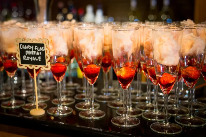 Champagne flutes prepared with fruit garnishes