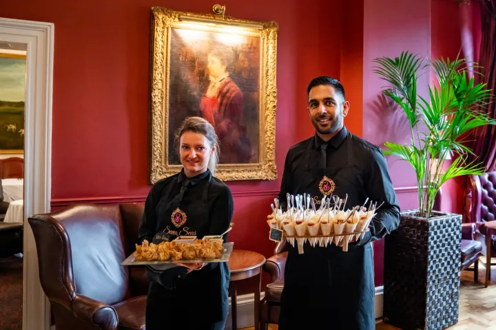 Servers presenting savoury cones and other canapés