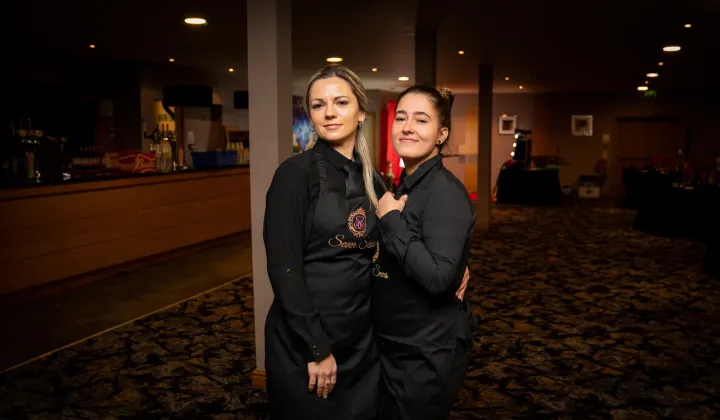 Two catering team members at an evening event