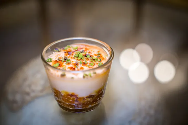An individual layered starter topped with garnish