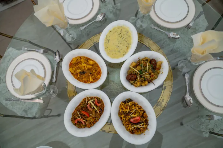 Sharing dishes arranged around a dining table