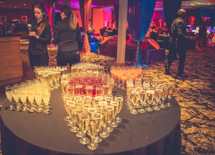 Colourful reception drinks beneath evening lighting