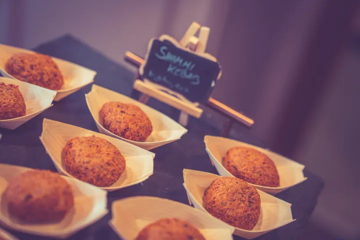 Golden savoury bites presented in small serving boats