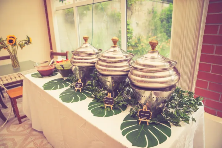 Polished buffet dishes on a dressed serving table