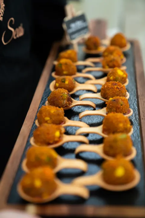A row of golden canapés on a serving tray