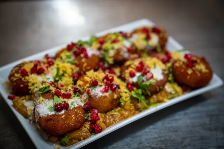 Savoury bites topped with yoghurt and pomegranate