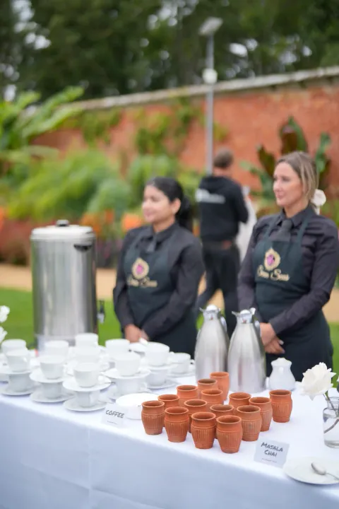 Servers preparing tea and coffee at an outdoor station