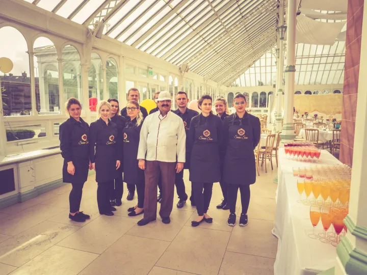 Chef and catering team in a bright conservatory