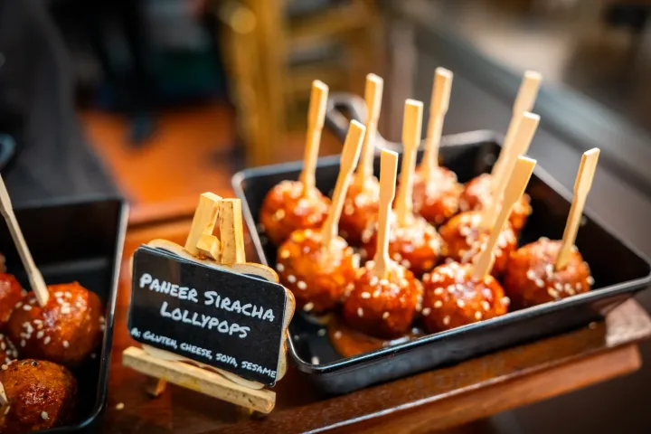 Paneer sriracha lollipops on a serving tray
