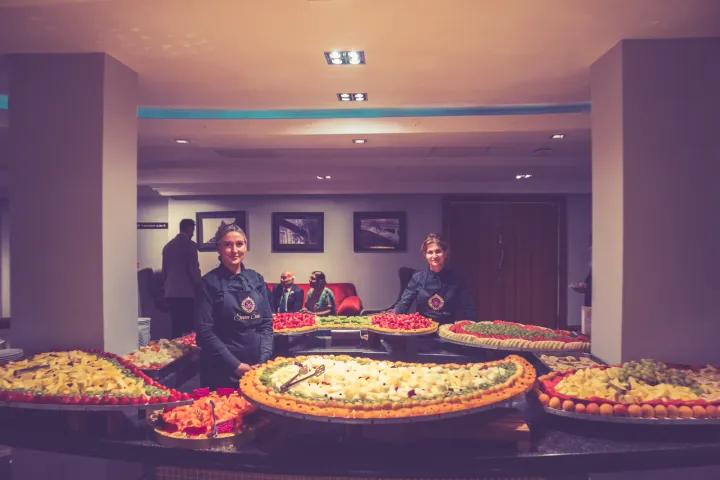 Servers behind a large buffet display