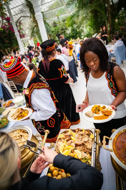 Guests choosing dishes at a conservatory buffet