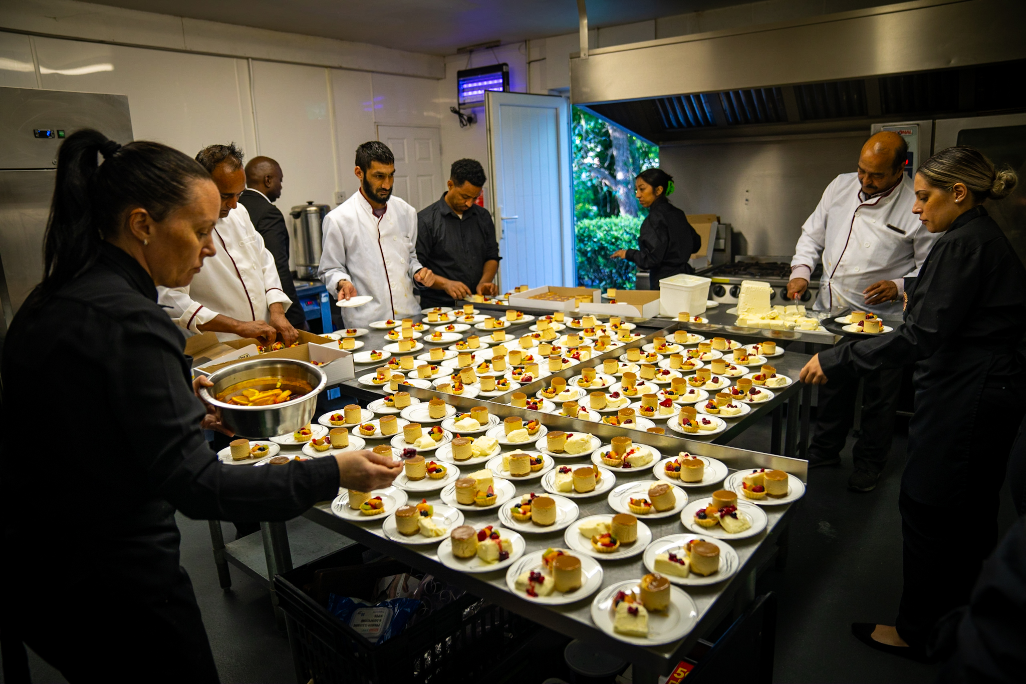 The Seven Seas kitchen team preparing plates of desserts together
