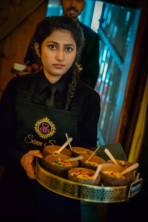 Server carrying bowls of starters