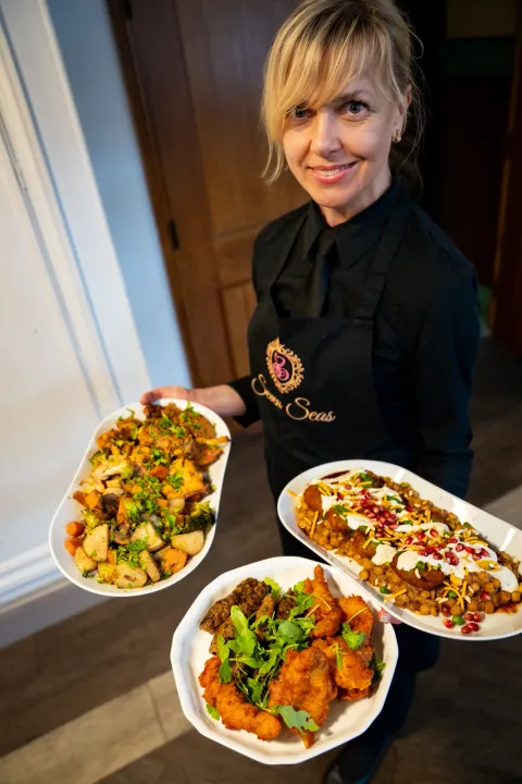 Server carrying platters of hot food