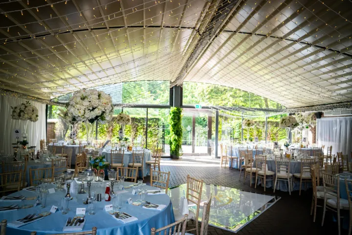 Reception tables in an airy garden-facing room
