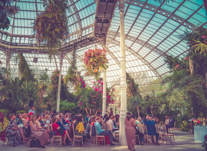 Guests celebrating among tropical glasshouse plants