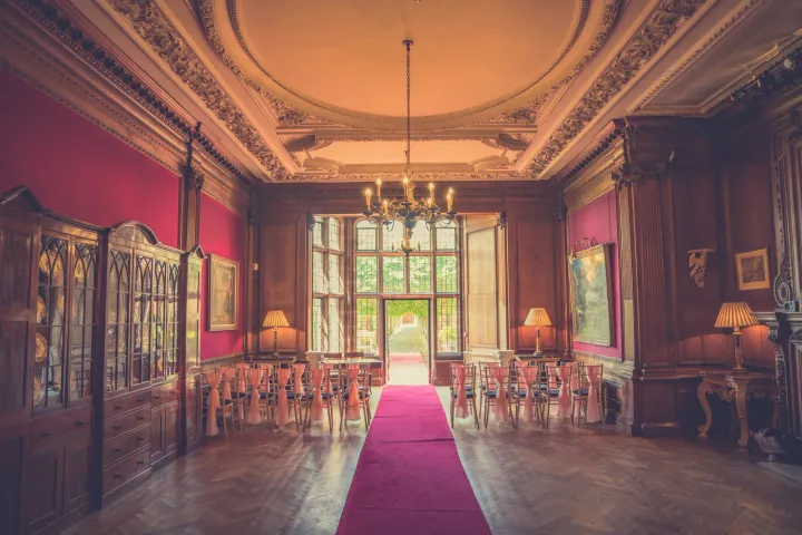 Red ceremony aisle in an ornate historic room