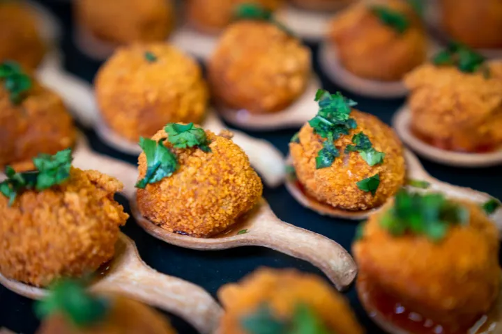 Golden canapés topped with fresh herbs