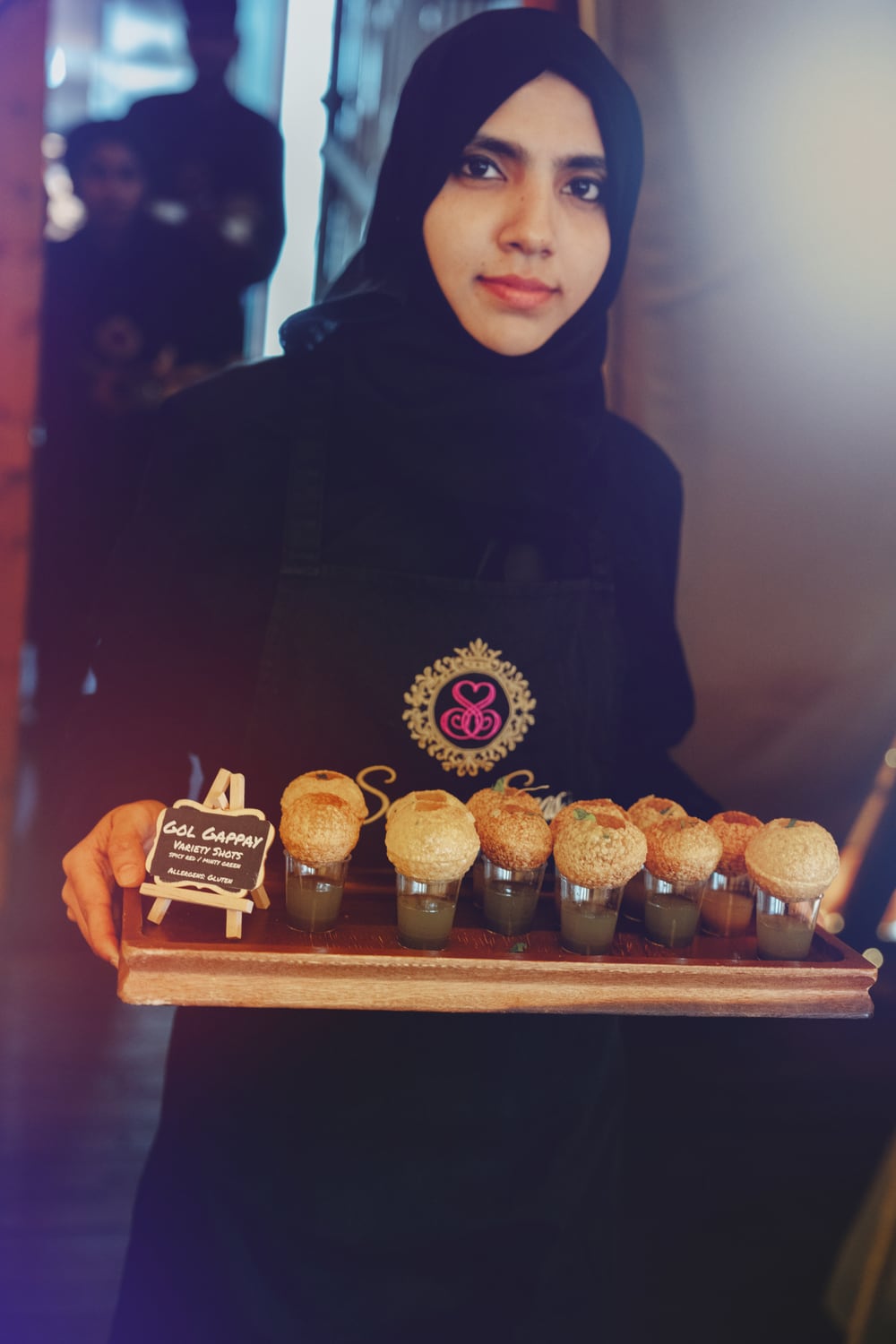 Seven Seas team member presenting pani puri canapés