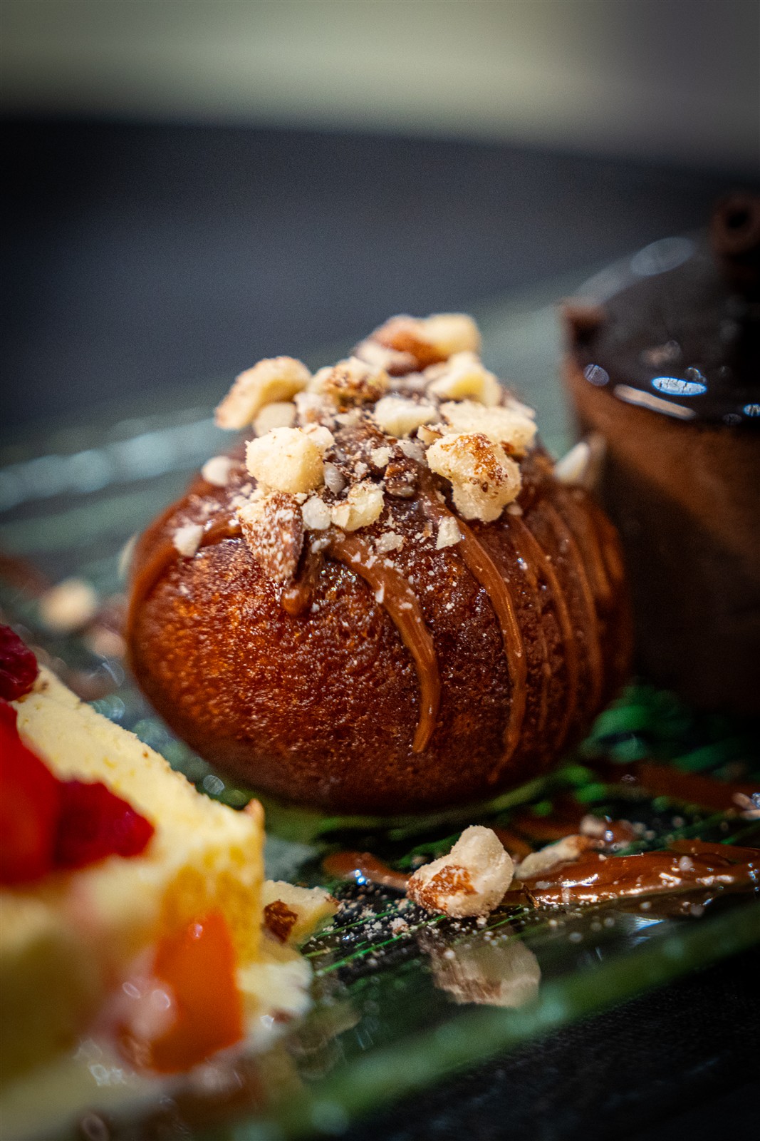 Dessert topped with chocolate and chopped nuts